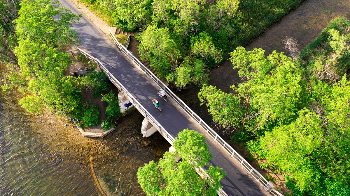 Aerial view of two cyclists riding the Central Lakes Trail on USBR 20 in Minnesota.