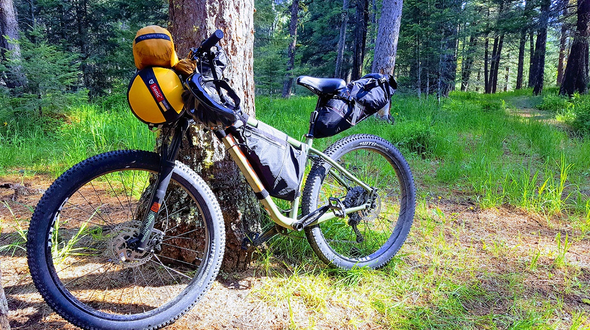 A hardtail mountain bike with bikepacking bags