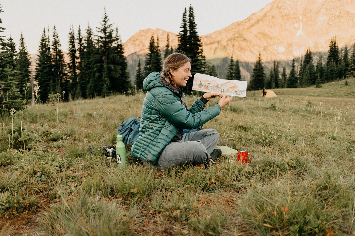 Anna Brones sits in an alpine meadow