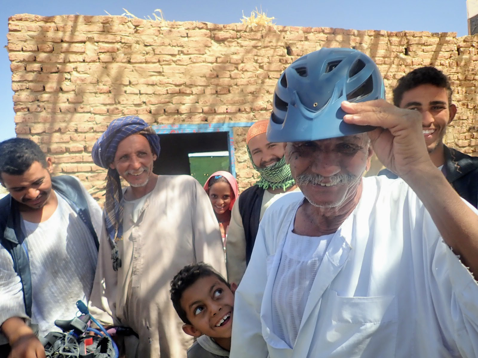 Sudanese man tries on bicycle helmet