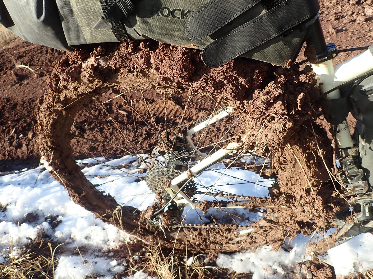 New Mexico mud caked to Alissa's rear wheel.