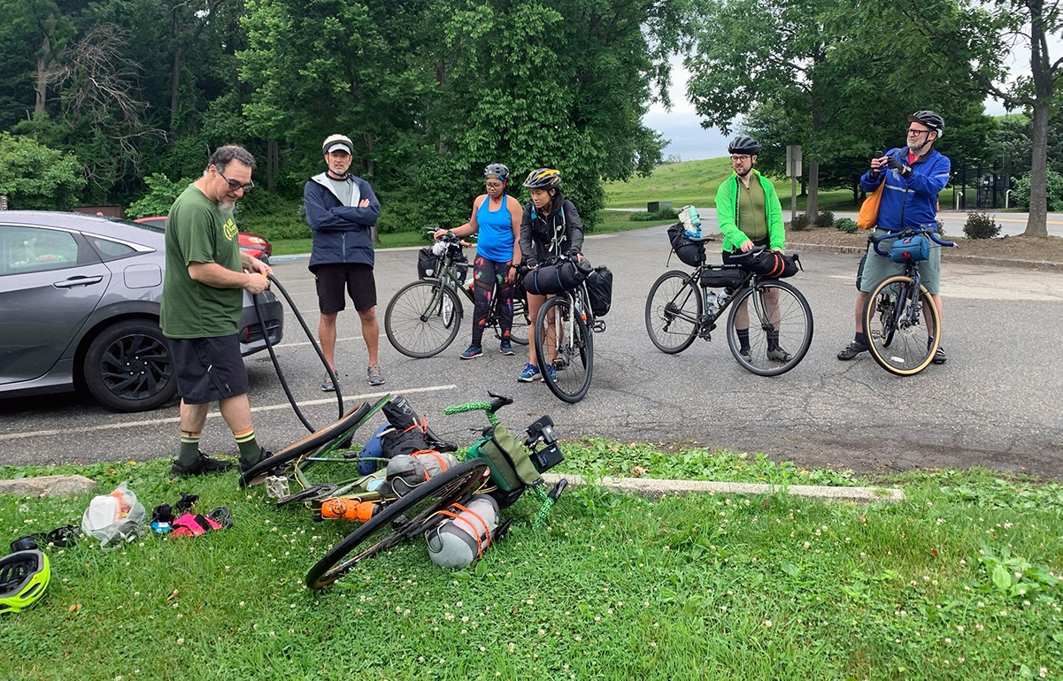 Joe Nocella shows a few in the group how to change a tire mid-trip