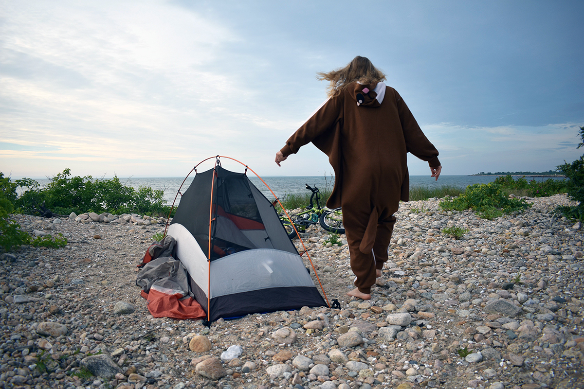 Laura wears a monkey onesie at a beach campout.