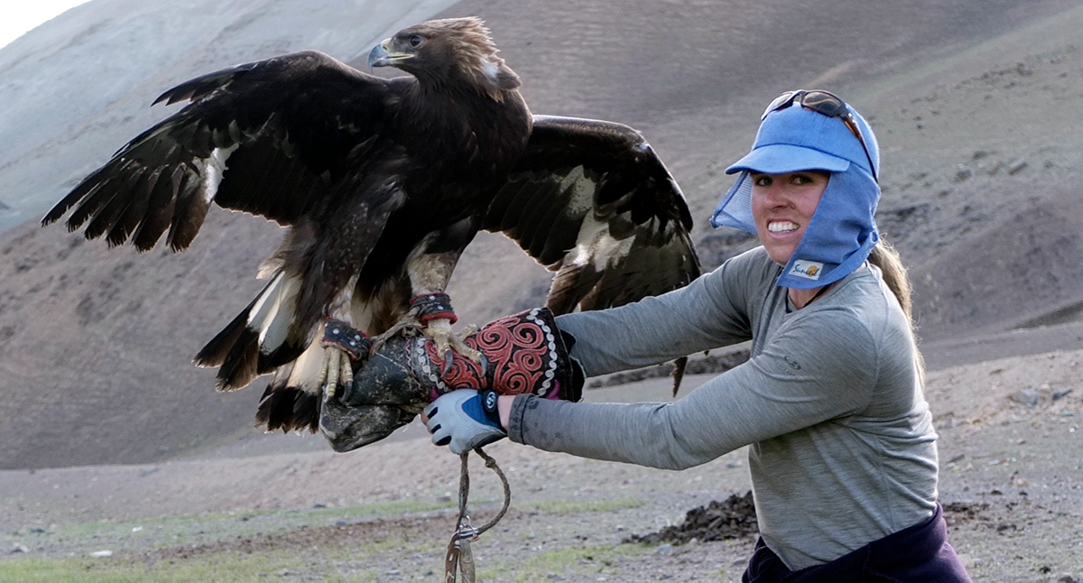 Tara holds an enormous eagle on her gloved arm.