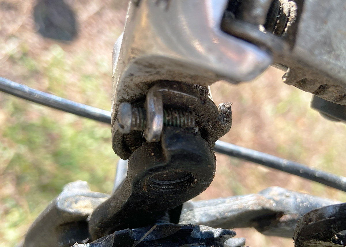 The image shows Hollie's broken b-limit screw. The screw is not resting against the metal plate of the derailer its supposed to. The metal plate is off to one side and the screw is resting against air.