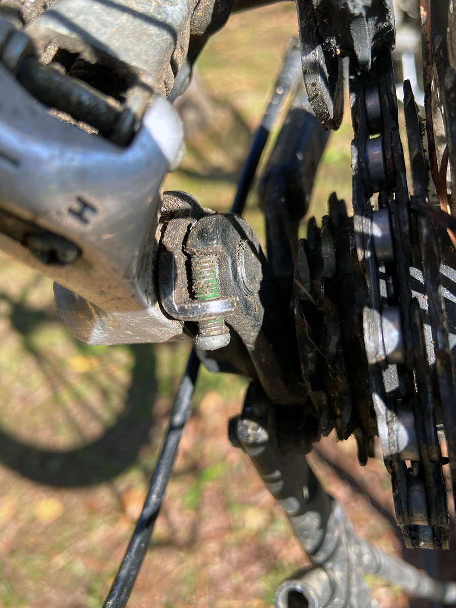 The image shows a greasy but functional b-limit screw correctly positioned in a rear derailer.