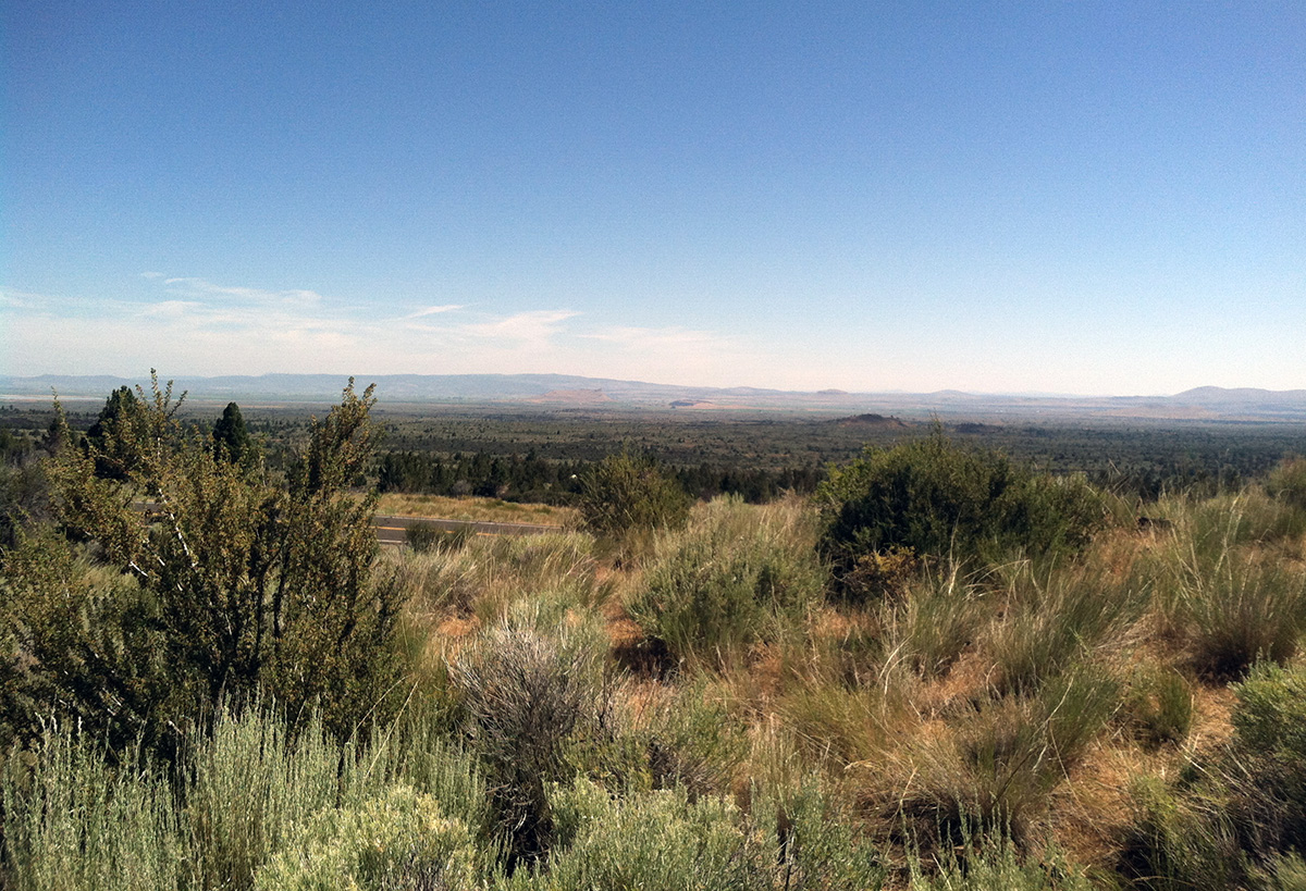 A view of a rural sagebrush landscape and blue sky