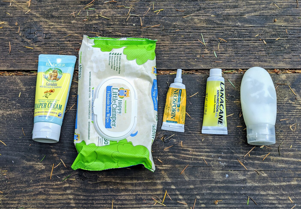 Four products Roxy has used for saddle sores in a line on a wooden picnic table.