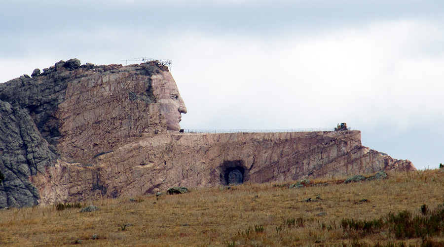 Crazy Horse Memorial is a carving of a face in the side of a rock cliff. In this photo you see the face in profile and can see that the memorial is under construction - lots of scaffolding.