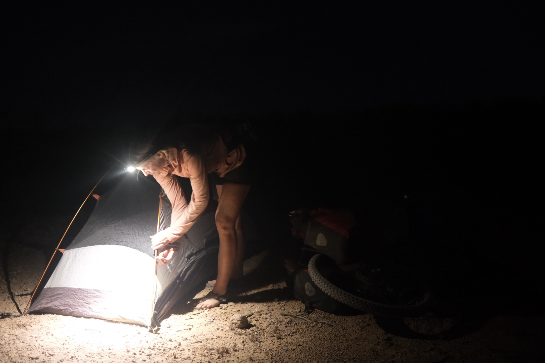 setting up a tent in the dark by headlamp