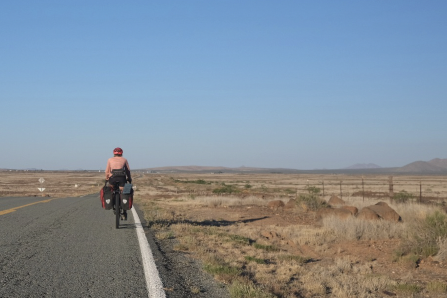a cyclist on a paved road