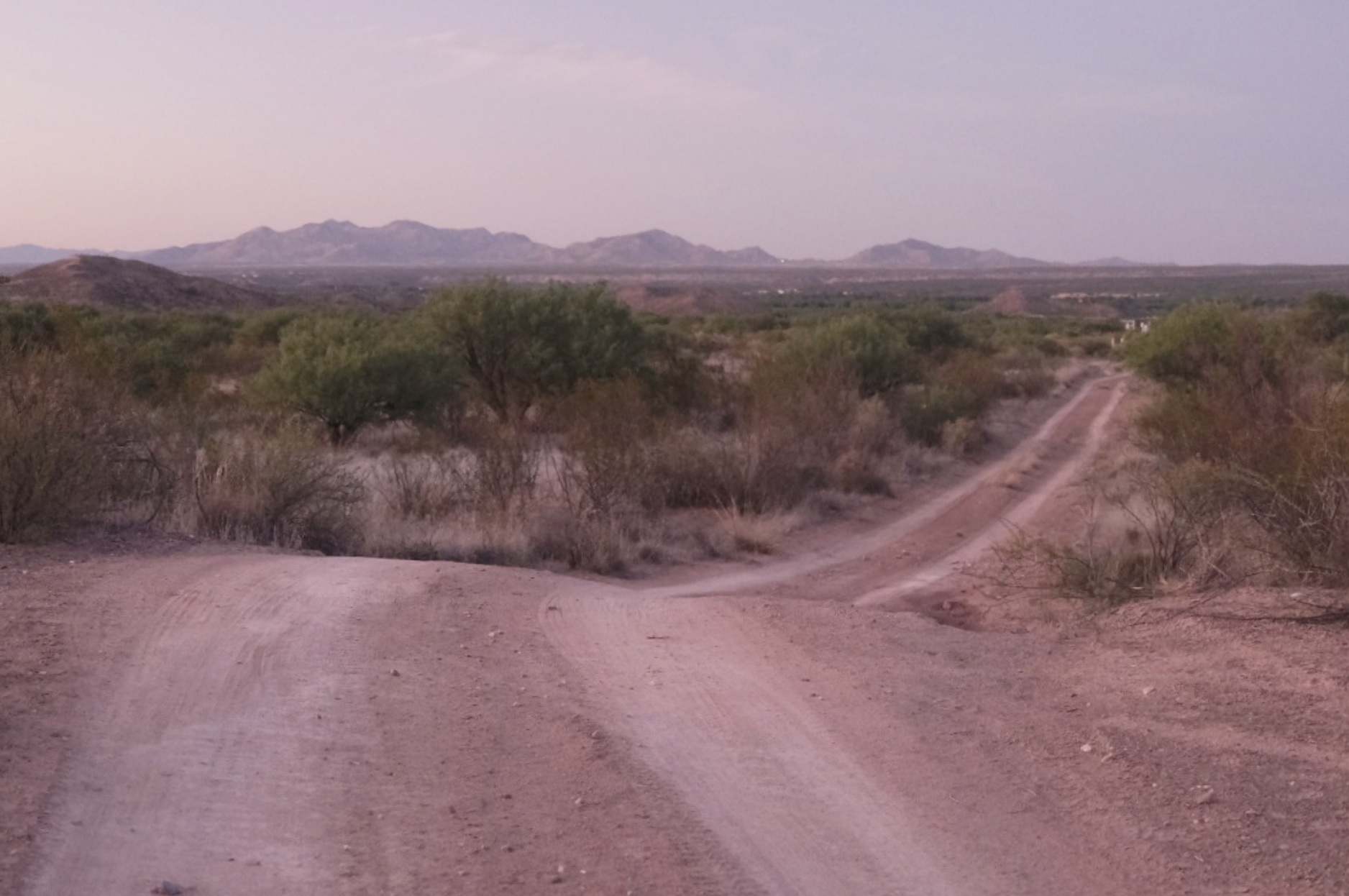 desert dirt road at sunset