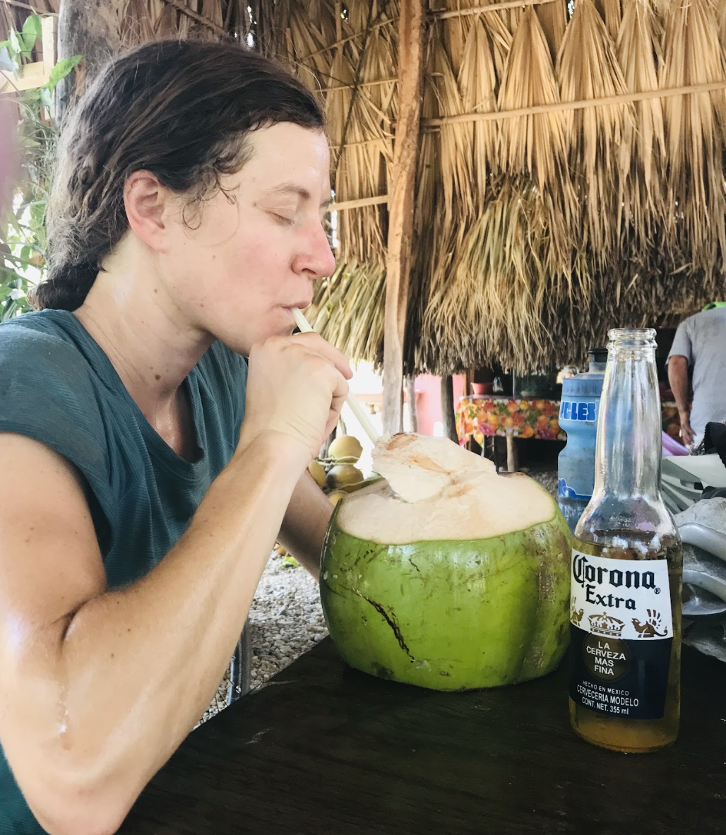 woman drinking from a coconut