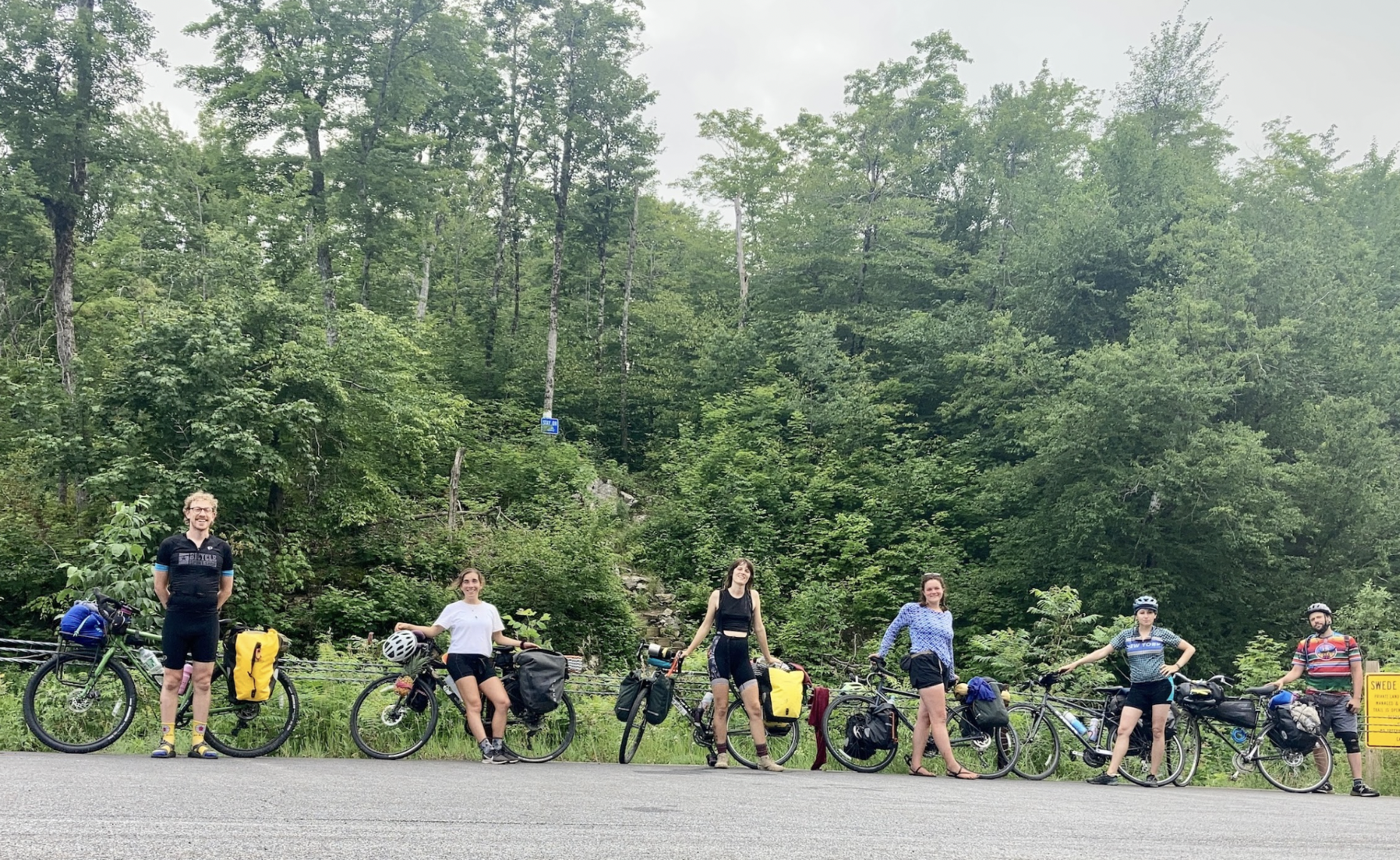cyclists on a paved road with bikes