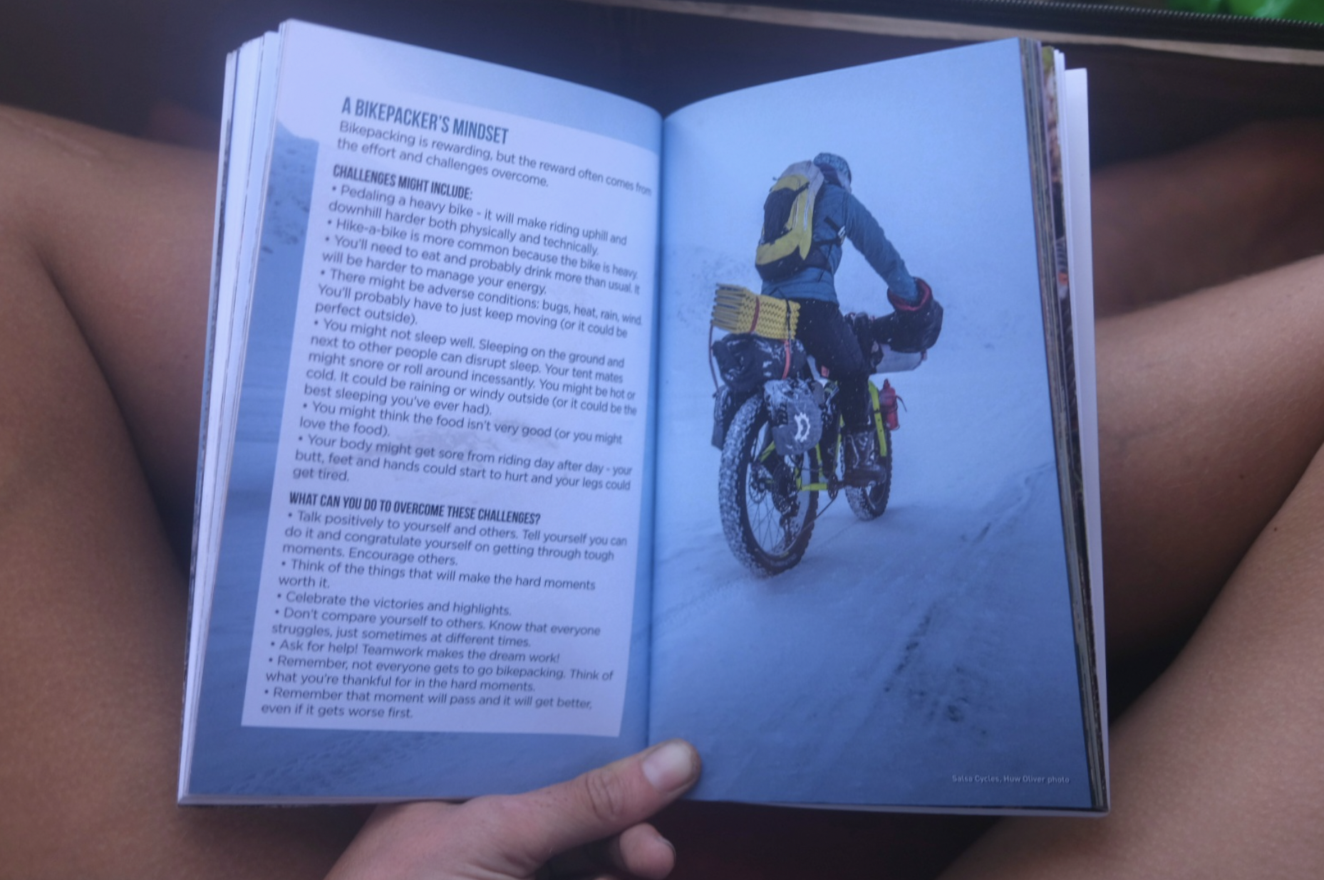 open book pages showing cycling photos and text