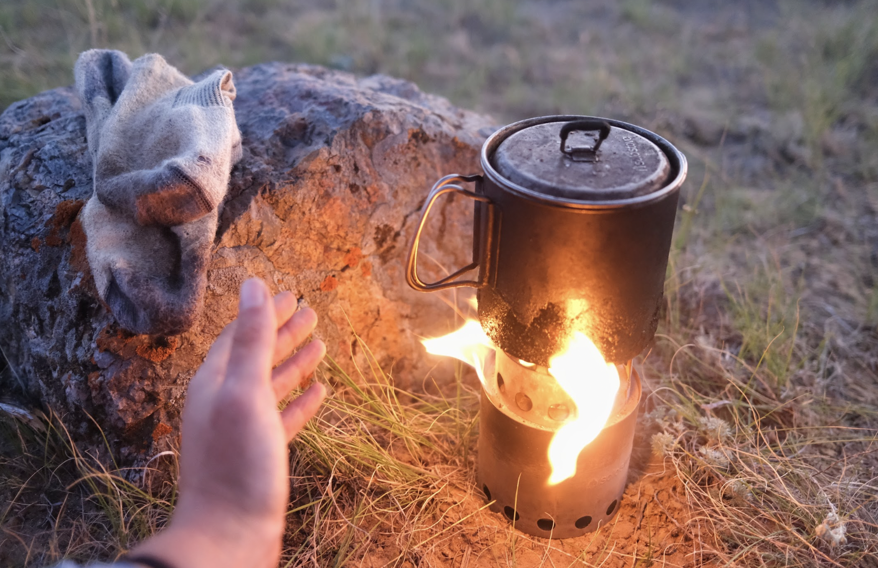 a twig stove with a flame 