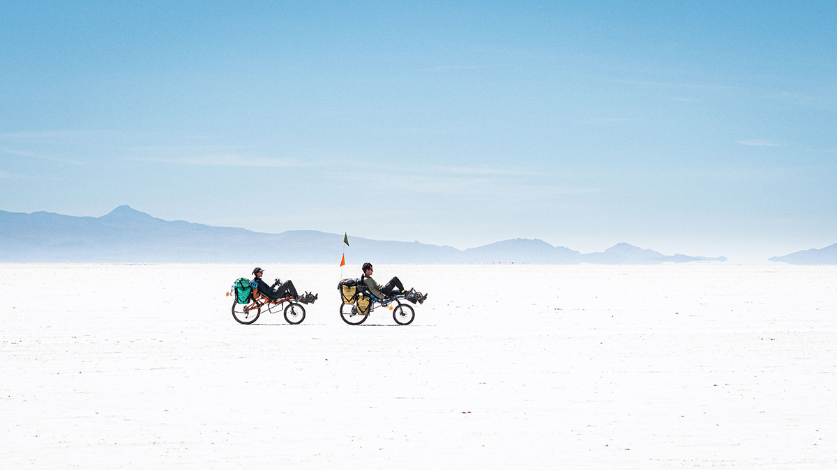Two recumbent cyclists make their way across the Bolivian salt flats