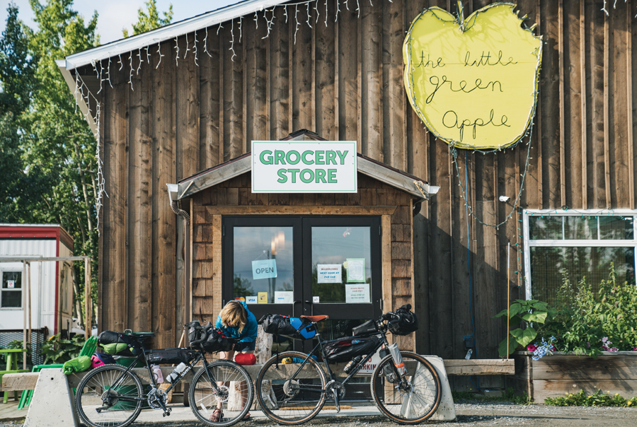 Elsa Sebastian sits outside the Little Green Apple Grocery store.