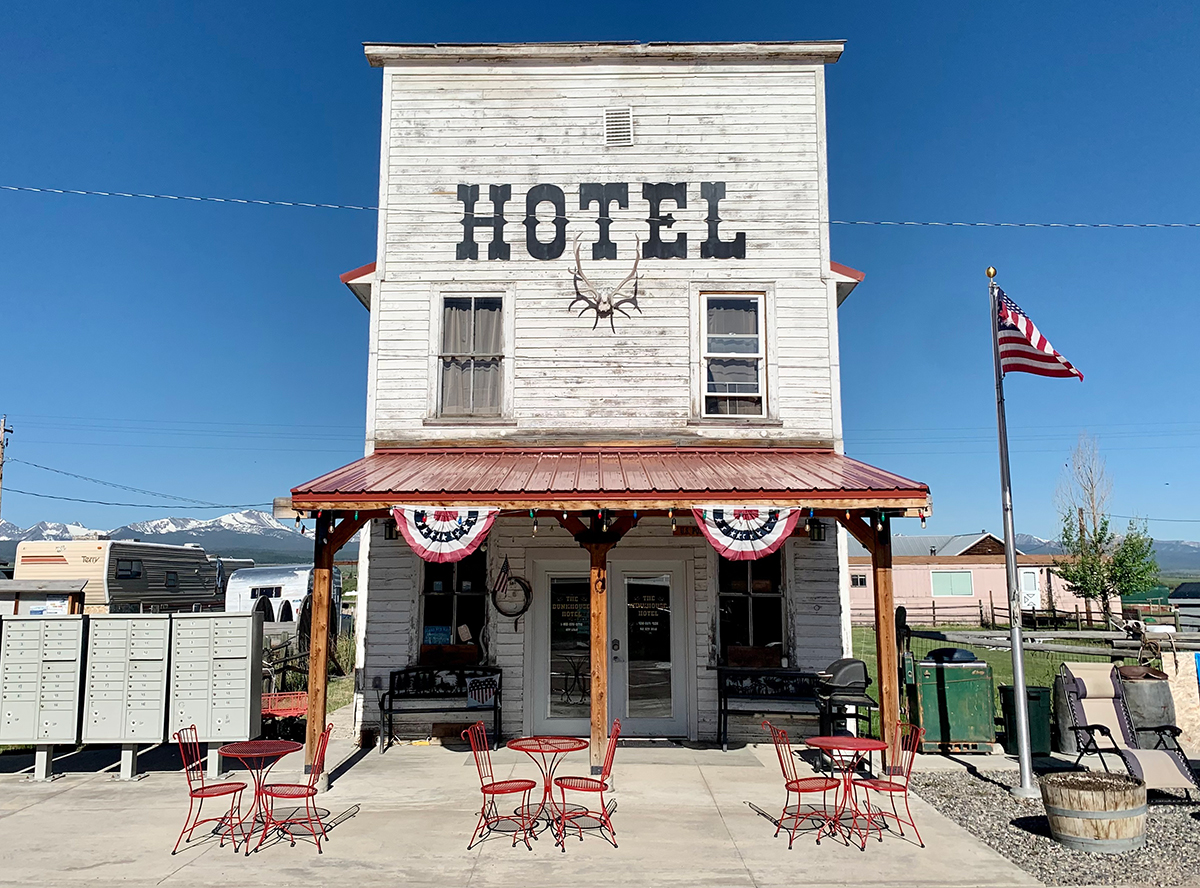 An old white building in a small mountain valley town