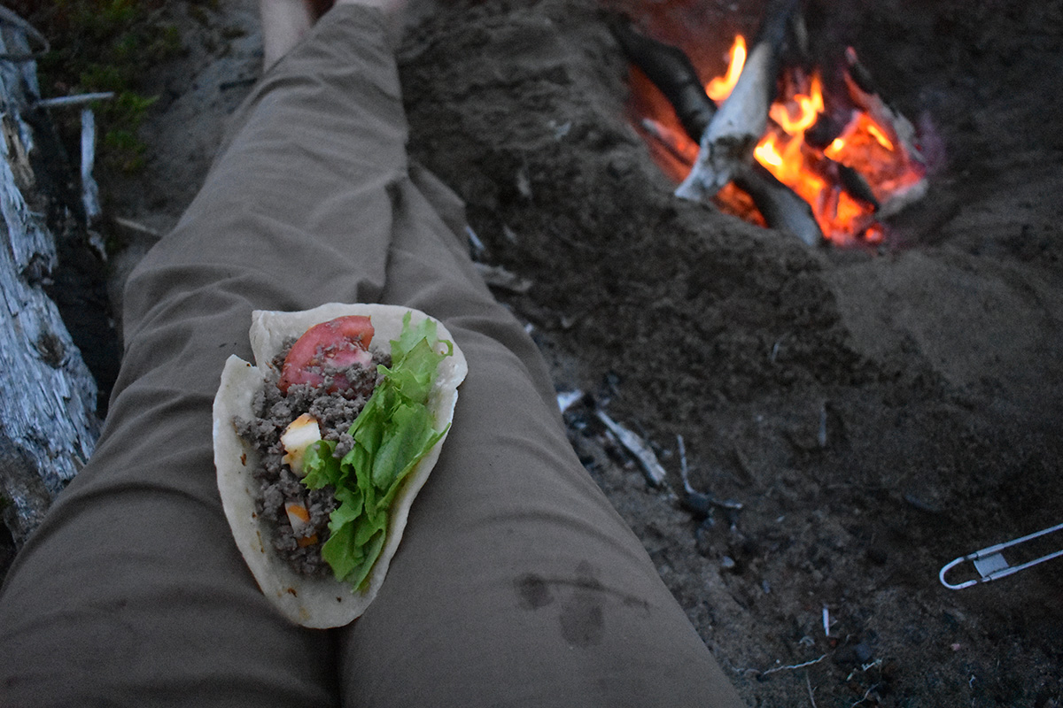 A fresh, warm taco sits on Laura's lap.