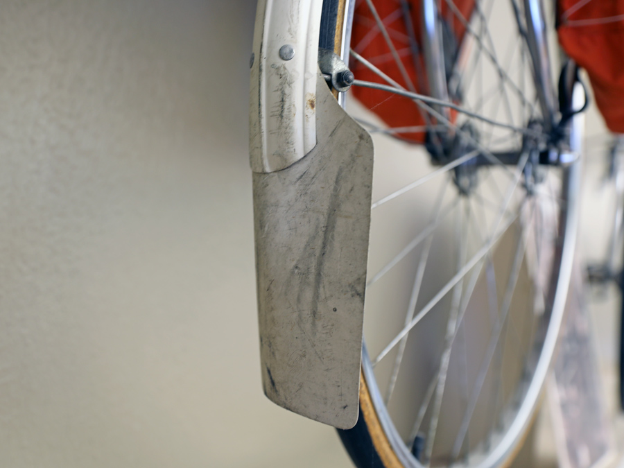 Mud flap attached to a metal full-length fender