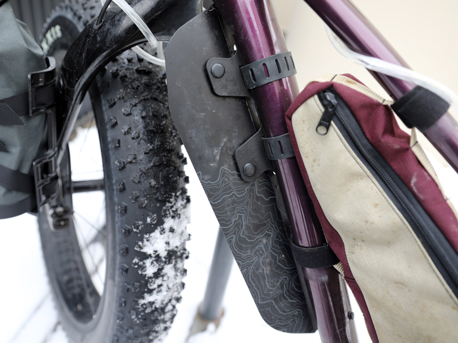 Plastic fender for the front tire attached to a fat bike.