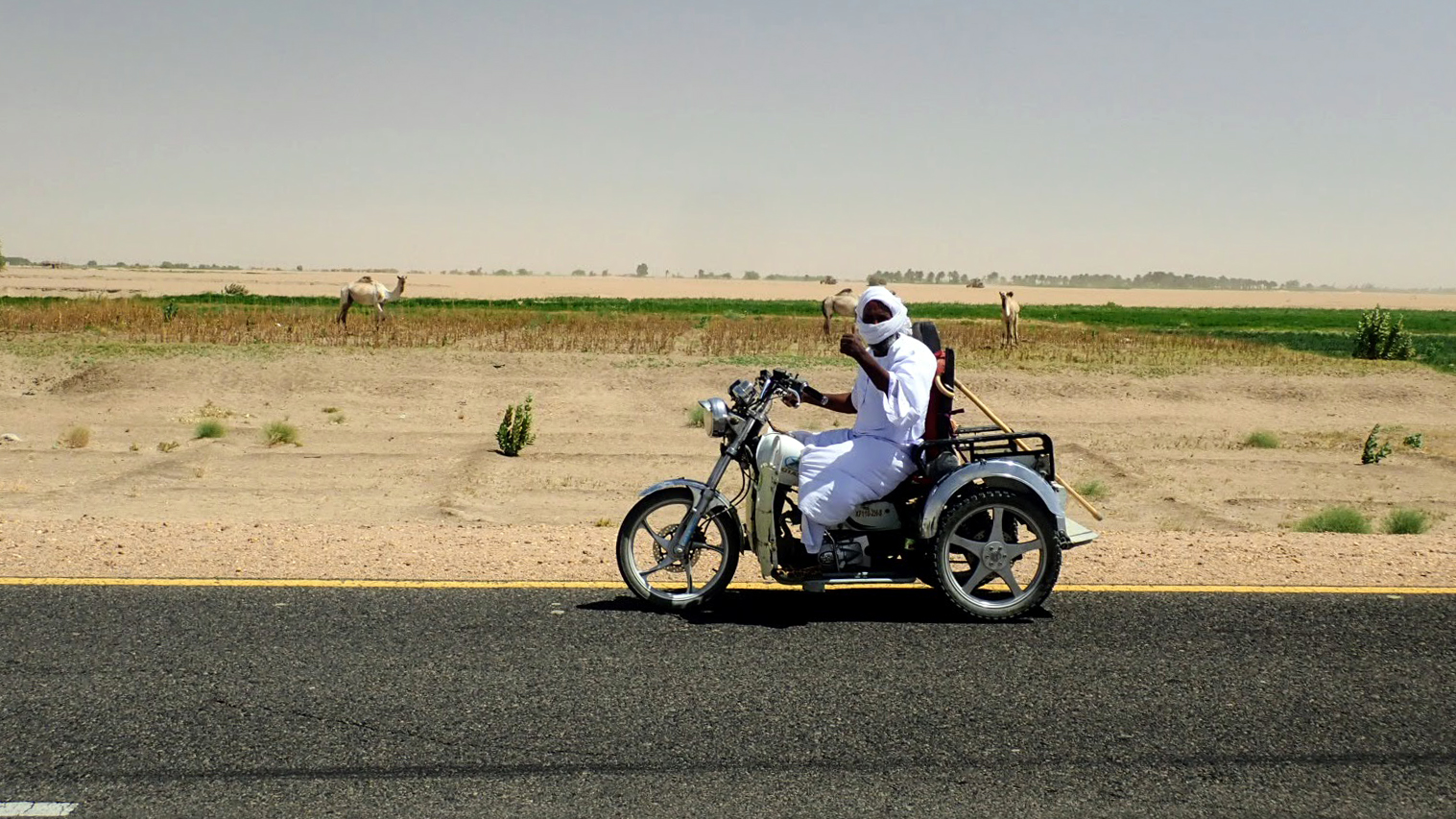 Sudanese man waving