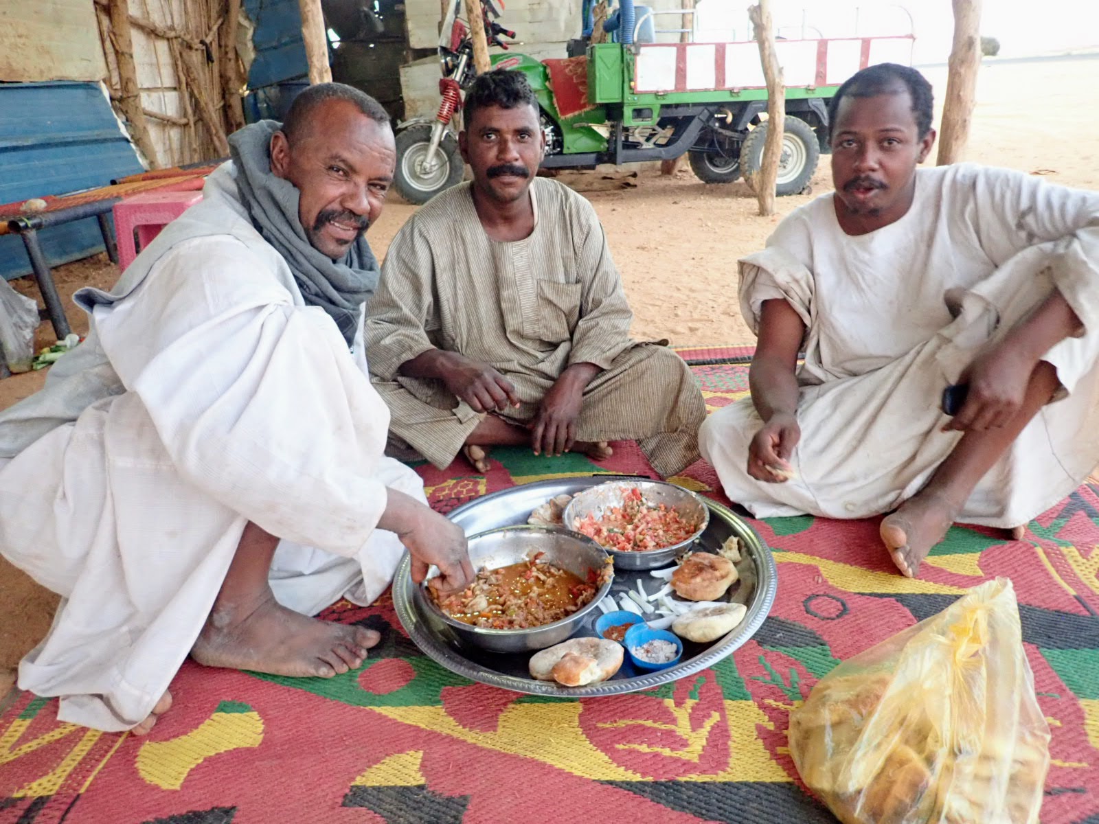 Sudanese men sharing food