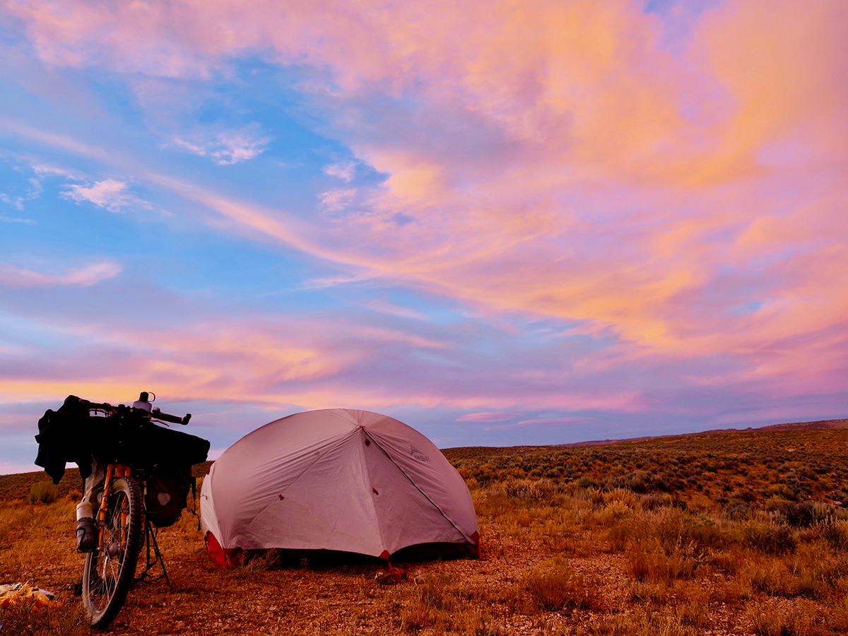 A campsite at sunset with an incredible array of colors in the sky