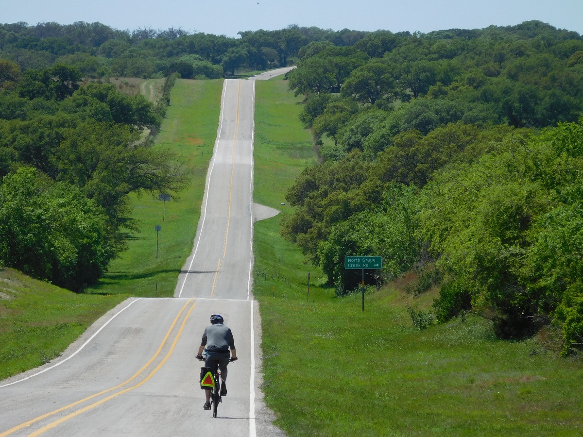 A cyclist rides the hills on the Texas Hill Country Loop