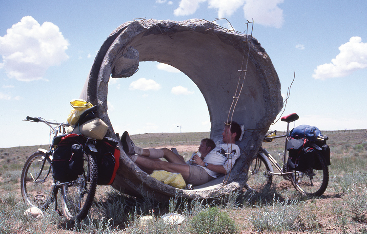 Abandoned construction tubes provide shade for Mike an Dan Moe.