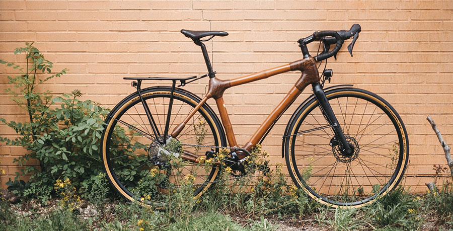 a bamboo bike against a salmon-colored wall