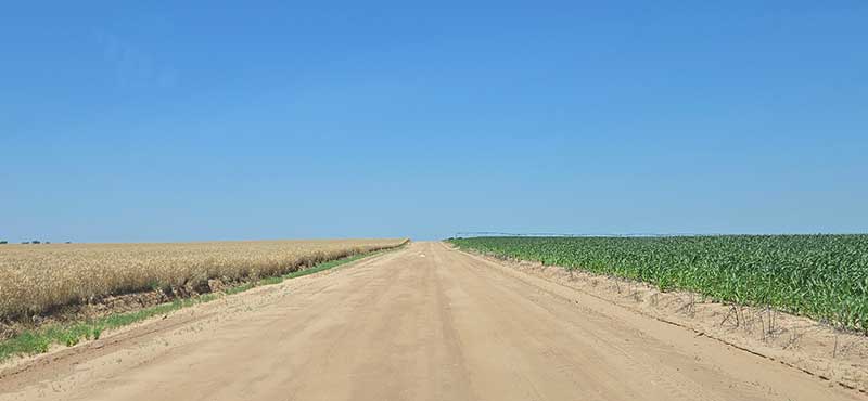 Arid farmland under an endless blue sky